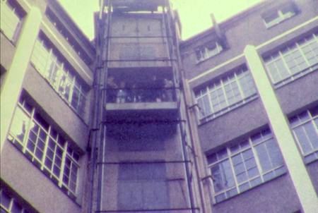 Screenshotof *FABRIKNEU 1973* - outside factory elevato - CLICK to watchr